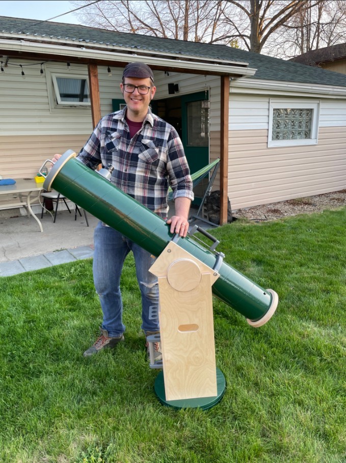 Nicolos Wethington with a telescope